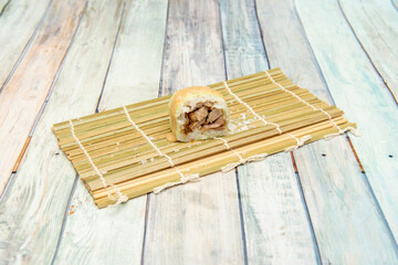 Piece of fusion sushi stuffed with meat