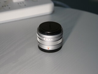 A very delicate and compact silver metal prime lens