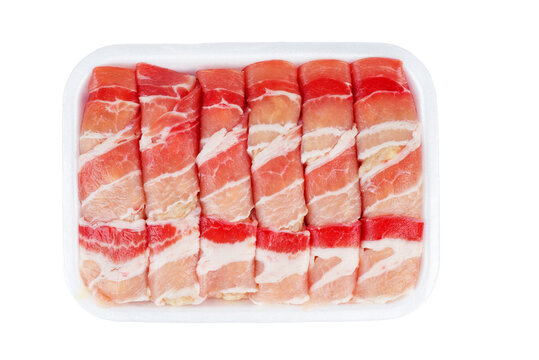 Ready to cook romanian meat rolls called mititei in plastic container .Isolated on white .
