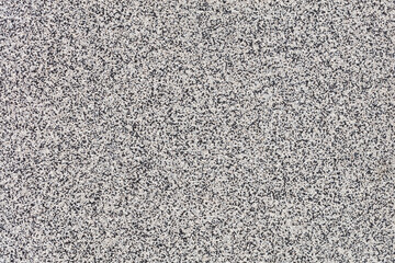 Texture and background of black and white facade plaster with fine granules.