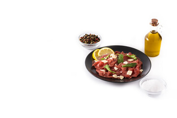 Marbled beef carpaccio on black plate isolated on white background