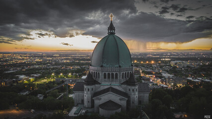 Aerial photography church in Montreal during storm sunset rain clouds in the sky - obrazy, fototapety, plakaty