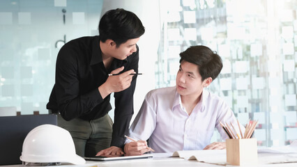 Image of engineer meeting for architectural project. working with partner and engineering tools on workplace