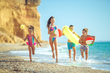 Cute children enjoying sunny day at beach. Summer camp. High quality photo