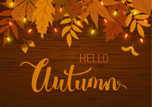 Autumn Fall Background With Leaves And  Hanging Festive Lights Bulbs Garland On Wooden Texture