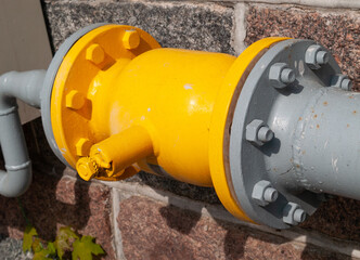 Yellow and gray gas pipe connector system close up.