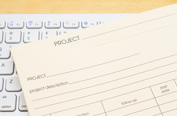 Manila project plan folder on a keyboard