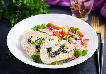 Meatloaf roll stuffed with spinach, olives, mushrooms and tomatoes salad. Diet menu.