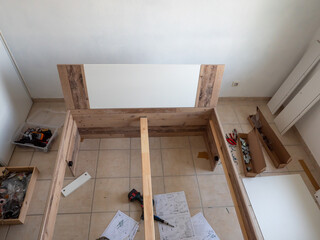 furniture - assembling the bed, lying tools and wooden elements needed for work.