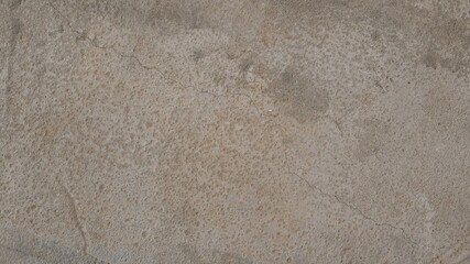 Textured concrete background. Old wall or floor made of beige plaster. Scuffed and cracked. Copy space. Attrition.
