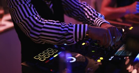 Dj playing music at cocktail bar outdoor at night time - Entertainment and party concept - Focus on left hand