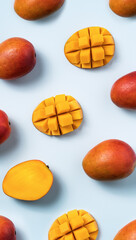 Mango design concept. Diced fresh mango fruit on blue table background.