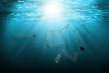 Pollution of ocean with plastic waste floating in the water. Environmental protection and ecology...