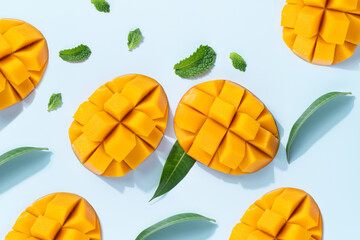 Mango design concept. Diced fresh mango fruit on blue table background.