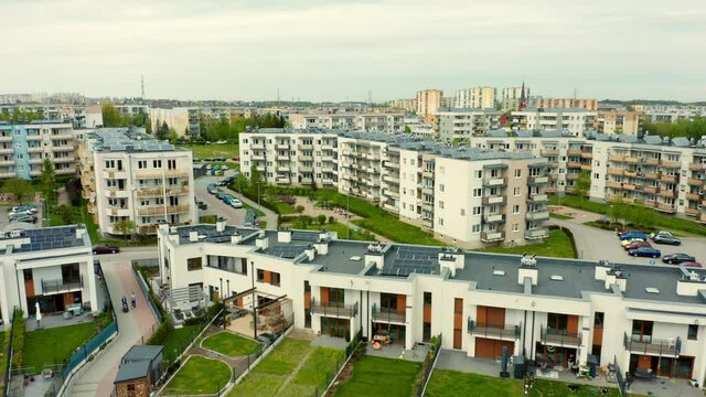 Aerial drone image of solar panels on the roofs of modern residential buildings for the production of environmentally friendly electricity. The concept of production of renewable energy sources. 