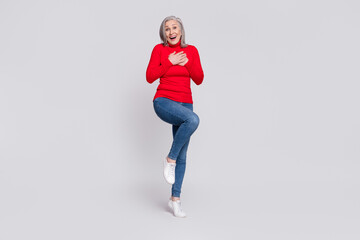 Fototapeta na wymiar Full size photo of excited aged woman happy positive smile hands on chest amazed surprised laugh isolated over grey color background