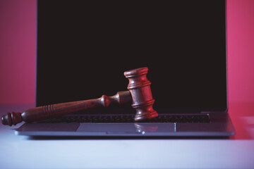 Wooden gavel on laptop. Justice and law concept