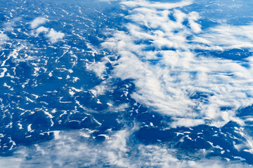 View from airplane to clouds and land