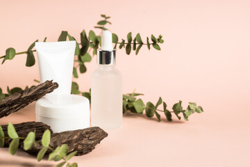Fototapeta na wymiar Natural cosmetic concept. Skincare product with natural leaves and tree bark at pastel background.