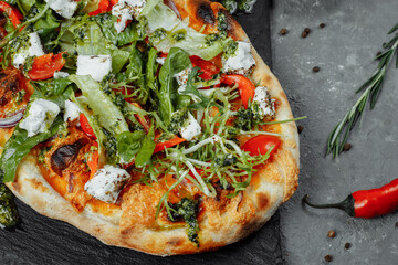 vegetarian pizza with cheese tomatoes and greens
