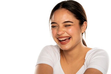 portrait of a young beautiful woman with braces laughing