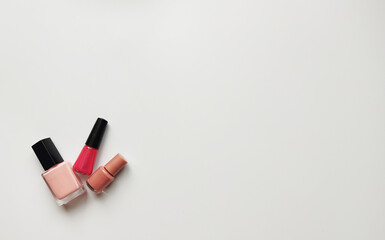 Set of pink nail polish on white background