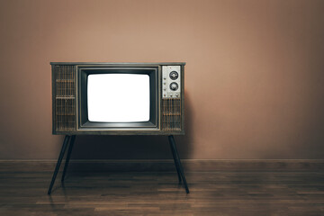 Retro old TV four legs with blank white screen on parquet floor in vintage room. copy space on the right