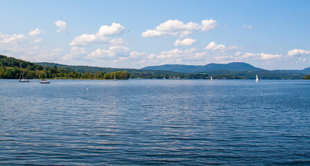Blue sky and puffy white clouds over calm Lake Memphremagog in Vermont, USA