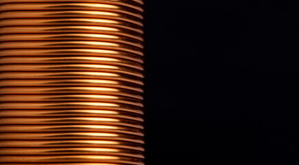 Close-up copper wire coil on black background. Copper wire industry for general electrical work with copy space on the right