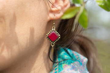 Close up of woman ear wearing beautiful earrings with mineral gemstone