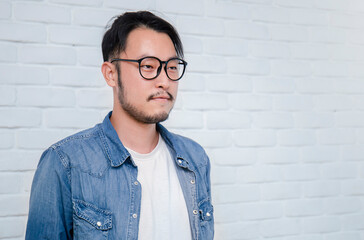 Attractive beautiful positive asian man, close up portrait of asian nerdy guy. Handsome nerd Japanese asia man wearing glasses isolated on white background.