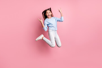 Full length body size view of pretty trendy cheerful girl jumping showing horn symbol isolated over...