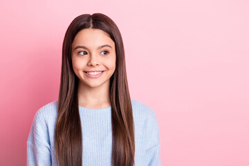 Portrait of attractive cheerful girl looking aside creating solution clue isolated over pink pastel...
