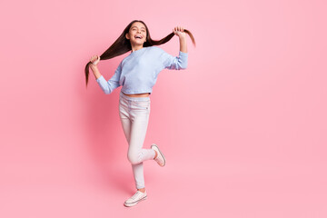 Fototapeta na wymiar Full length body size view of attractive dreamy cheerful girl having fun making tails isolated over pink pastel color background