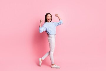 Full length body size profile side view of pretty cheerful girl going having fun rejoicing isolated over pink pastel color background