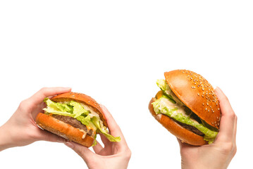 Hamburger in woman hands isolated on a white background.