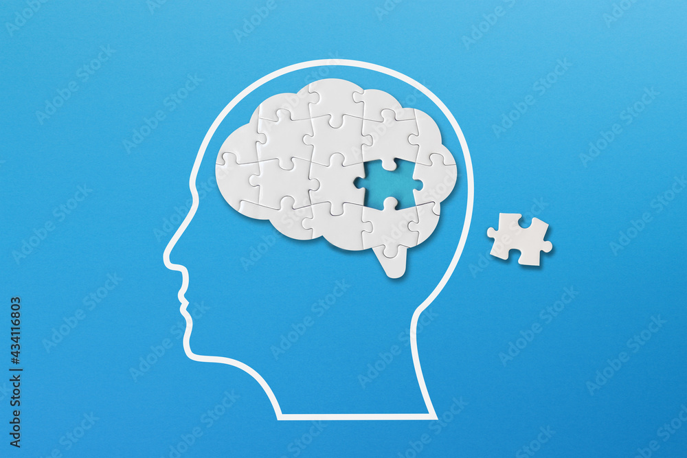 Wall mural brain shaped white jigsaw puzzle on blue background, a missing piece of the brain puzzle, mental hea