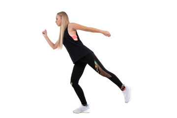Athletic young woman in a pink top, leggings and sneakers squats on a white background