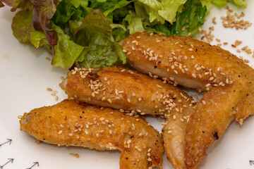 Grilled chicken wings with sweet and spicy sauce with sunny lettuce