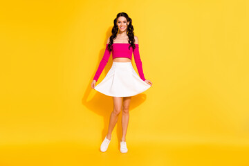 Full length photo of young attractive girl happy positive smile wear casual outfit isolated over yellow color background