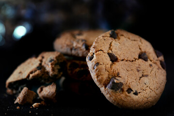 chocolate chip cookie on black background low key studio