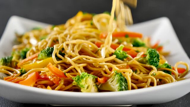 eating stir fry noodles with chopsticks