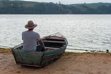 Closeup shot of a fisherman on the boat looking at the sea