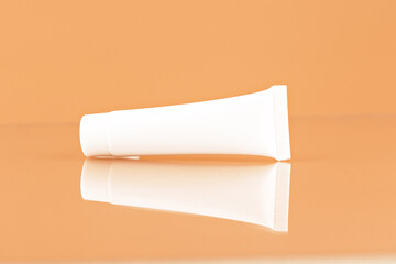 Unbranded plastic tube for cosmetics products. Skincare and cosmetology mockup. Branding identity mockup concept