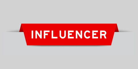 Red color inserted label with word influencer on gray background