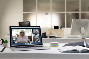 Fototapeta premium Diverse group of people having business video call on screen of laptop on desk