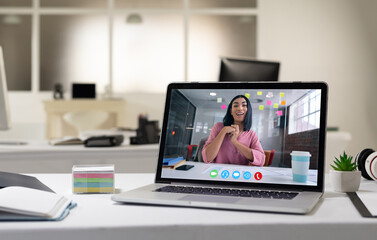 Fototapeta premium Mixed race woman having business video call on screen of laptop on desk