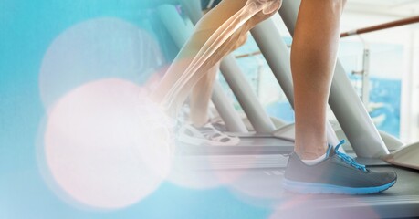 Composition of man running on treadmill with leg bones visible and spots of light