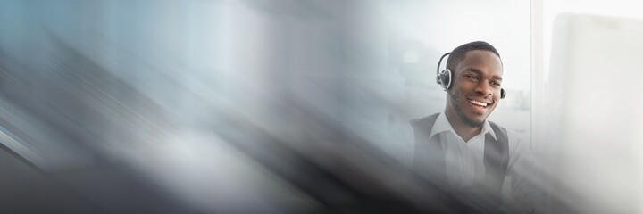 Composition of happy african american businessman wearing phone headset in office with motion blur