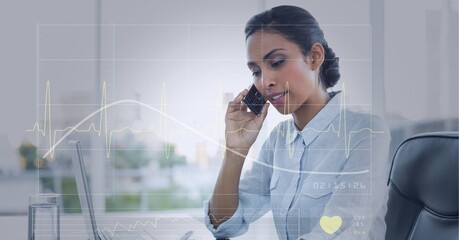 Mid section of caucasian businesswoman talking to smartphone against black background at the office